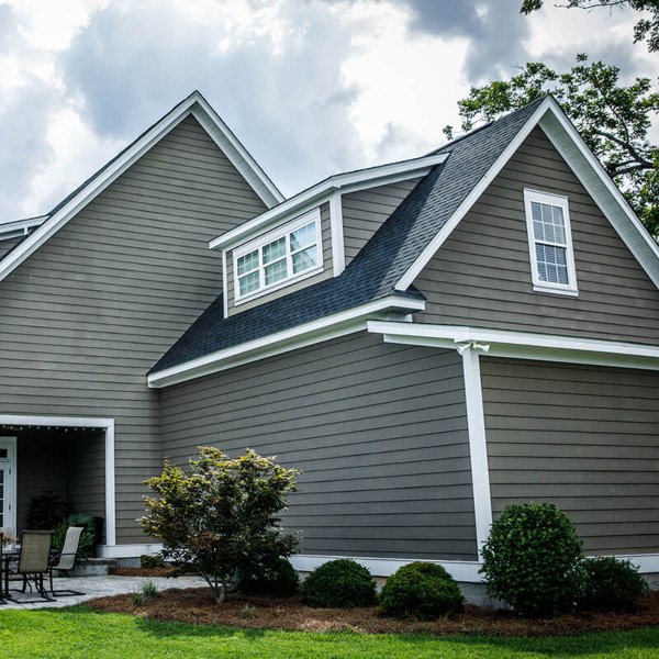 Worker Installing New Siding on a House for Rain Gutter Medic in Salt Lake City, UT